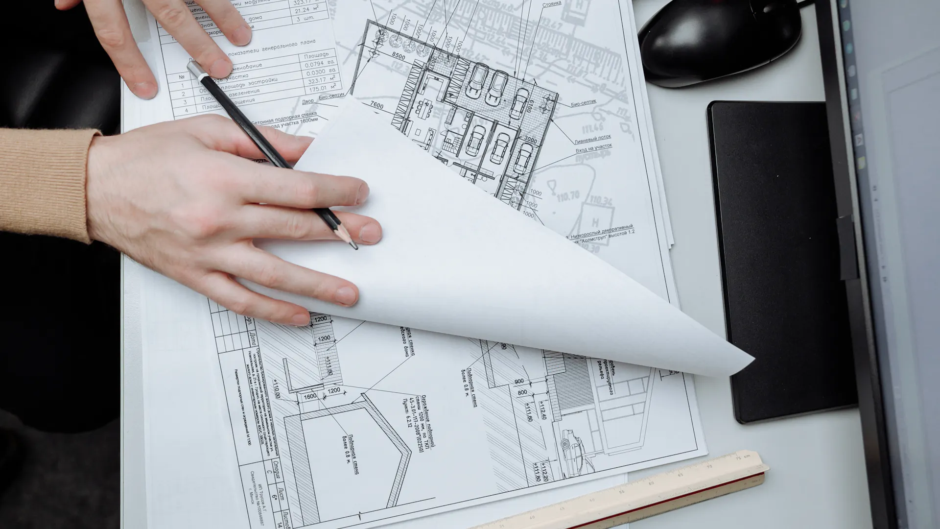 Architect reviewing construction drawings spread across a desk for a Chesterfield structural permit submission